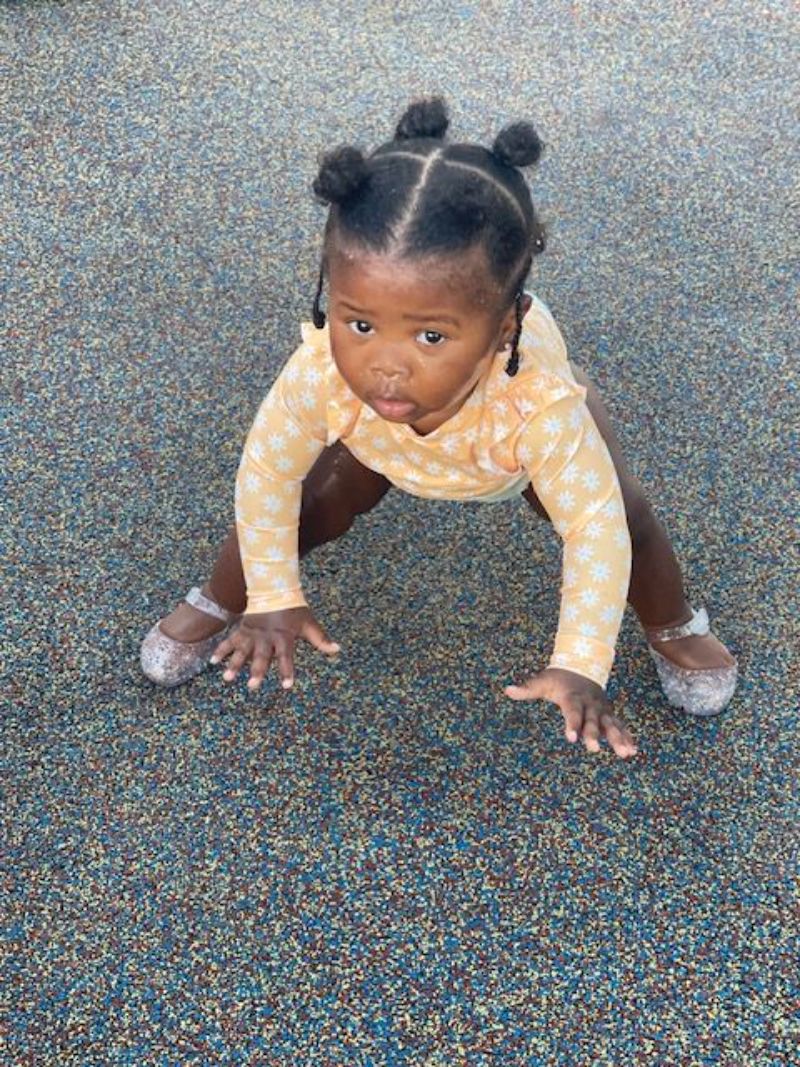 toddler girl getting up from the ground