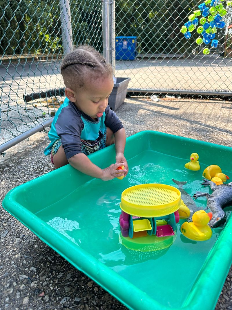boy playing with a water table