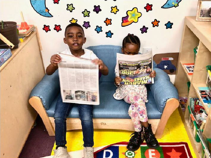 kids reading a newspaper