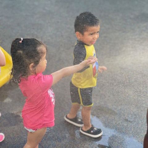 young kids playing in the rain